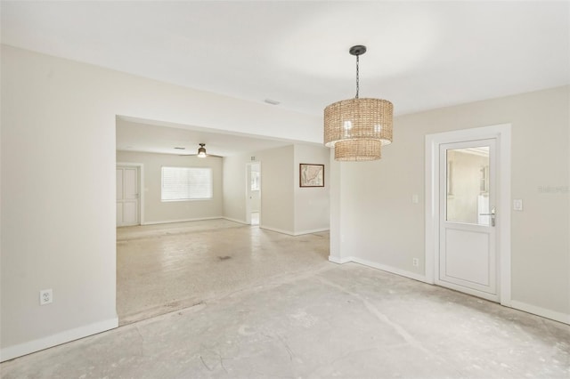 unfurnished room featuring ceiling fan with notable chandelier