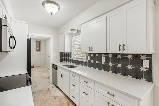 kitchen featuring white cabinets, sink, appliances with stainless steel finishes, and tasteful backsplash