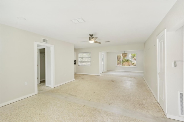 spare room with ceiling fan and light colored carpet