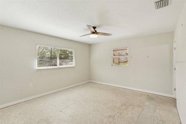 empty room featuring light colored carpet and ceiling fan