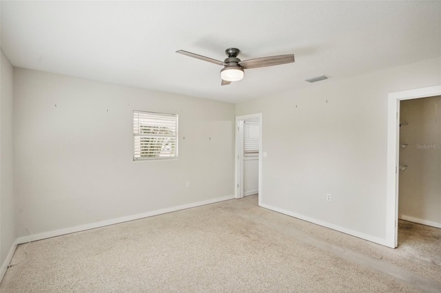 unfurnished room with ceiling fan and light carpet