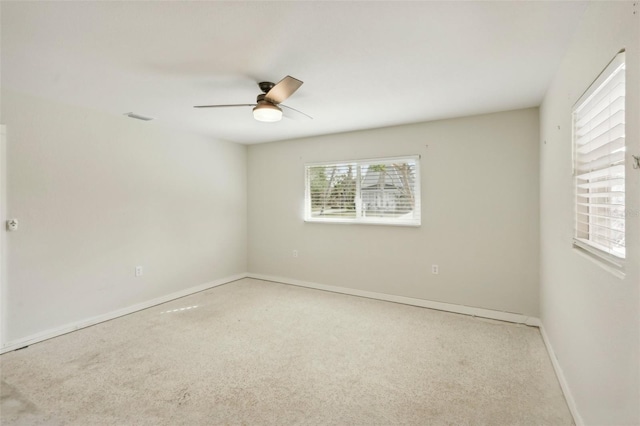 unfurnished room with carpet and ceiling fan