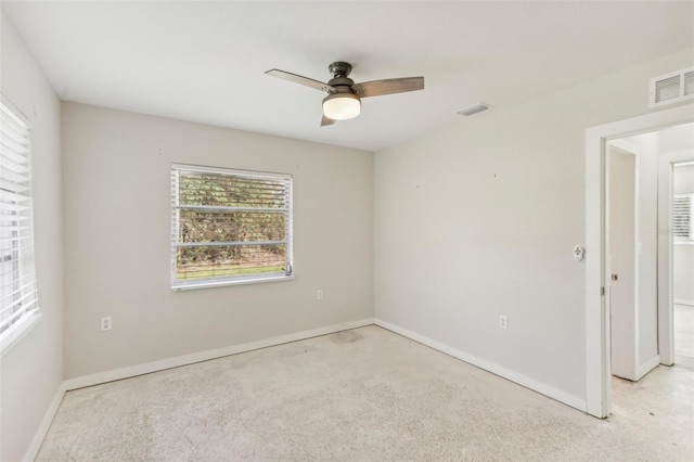 carpeted empty room featuring ceiling fan