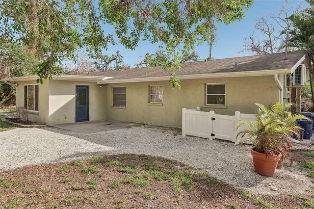 back of property with a patio