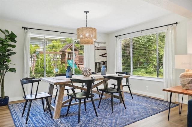 dining space with a chandelier and wood-type flooring