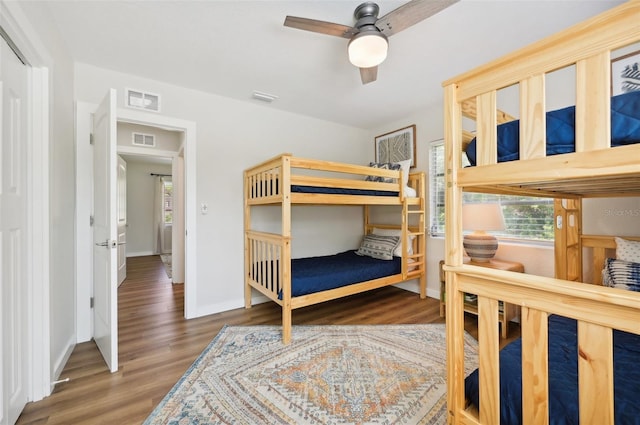 bedroom with ceiling fan and dark hardwood / wood-style flooring