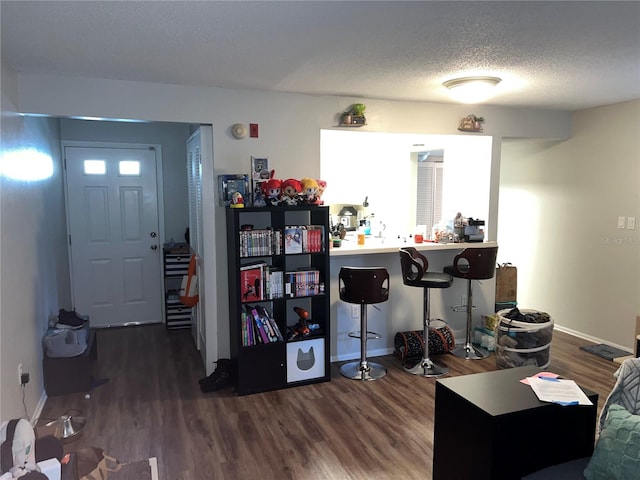 interior space with a textured ceiling and dark hardwood / wood-style flooring