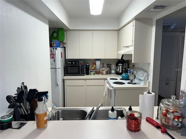 kitchen featuring sink and white appliances