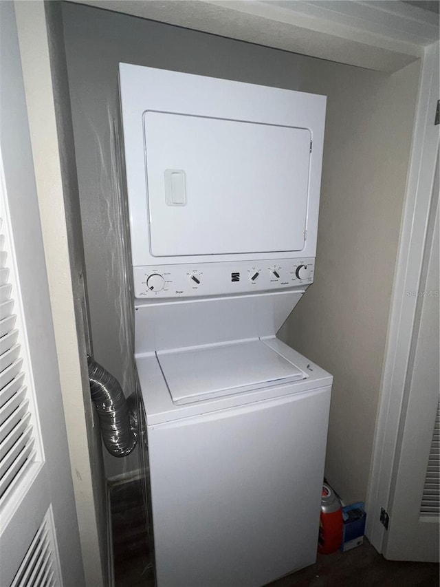 washroom featuring stacked washer / dryer