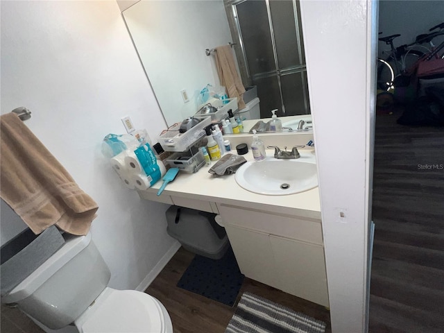 bathroom featuring vanity, toilet, and hardwood / wood-style flooring