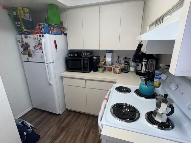 kitchen featuring white appliances, dark hardwood / wood-style flooring, and white cabinets