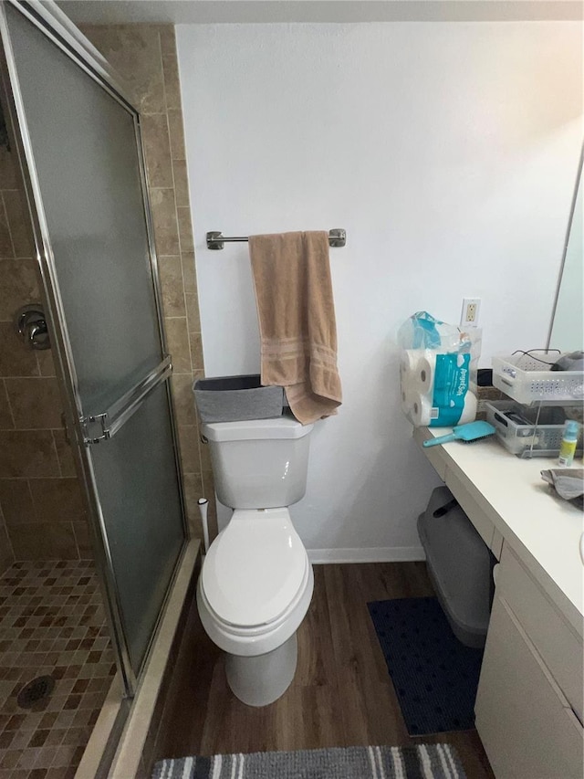 bathroom featuring hardwood / wood-style floors, vanity, toilet, and an enclosed shower