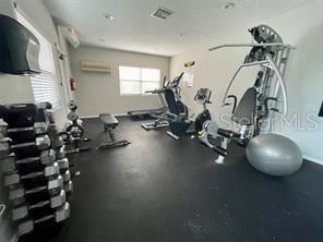 gym with an AC wall unit