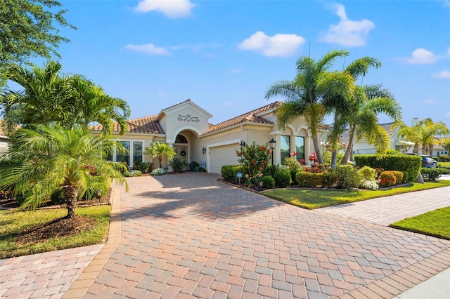 mediterranean / spanish home featuring a garage