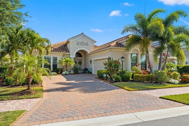 mediterranean / spanish-style house with a garage