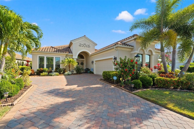 mediterranean / spanish house with a garage