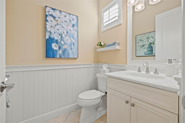 bathroom featuring tile patterned flooring, vanity, and toilet