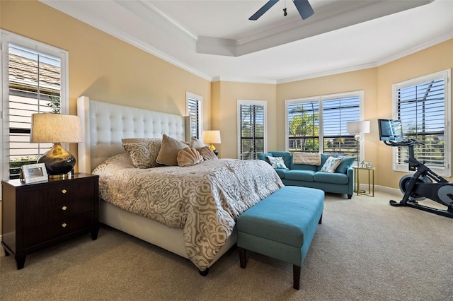 bedroom with light carpet, a raised ceiling, ornamental molding, and ceiling fan