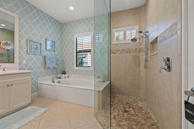 bathroom with independent shower and bath, vanity, and tile patterned floors