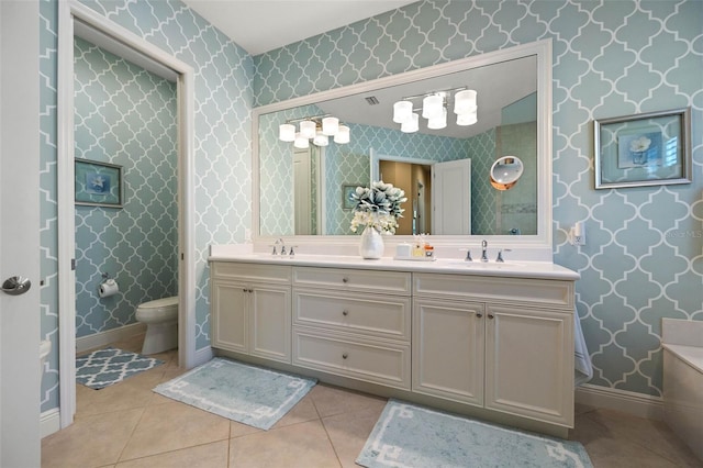 bathroom with tile patterned flooring, vanity, and toilet