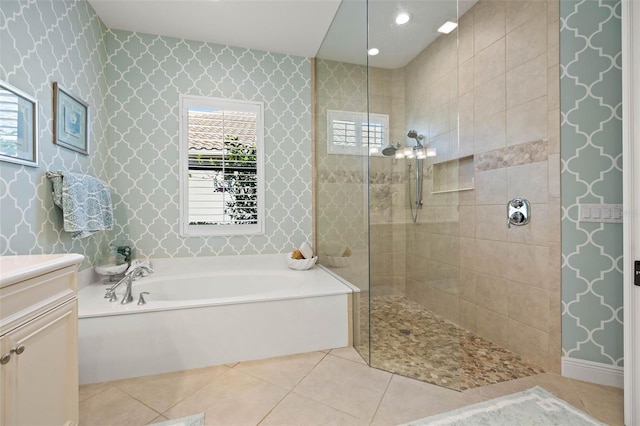 bathroom featuring plus walk in shower, tile patterned flooring, and vanity