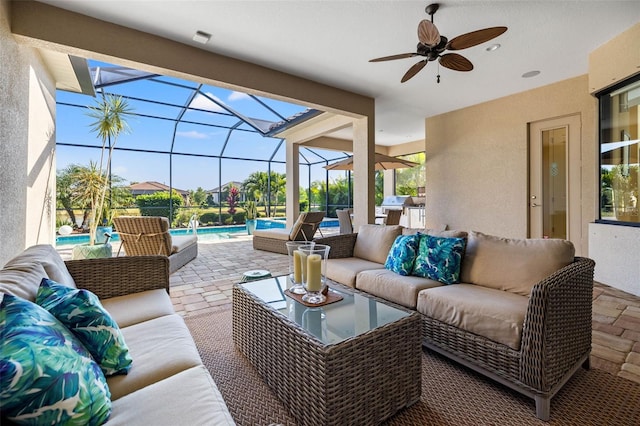 view of patio featuring a lanai, ceiling fan, and outdoor lounge area