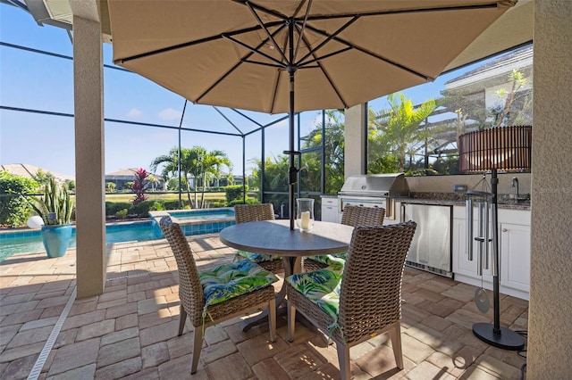 view of patio / terrace featuring an outdoor kitchen, a lanai, and a grill