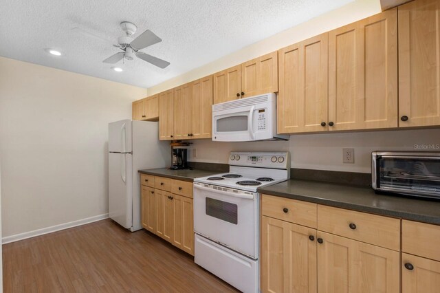 kitchen featuring white appliances, dark hardwood / wood-style flooring, light brown cabinets, a textured ceiling, and ceiling fan