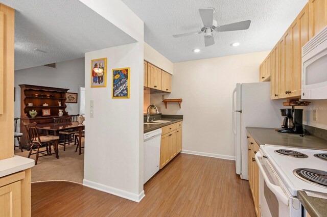 kitchen with white appliances, light wood-type flooring, a textured ceiling, light brown cabinetry, and ceiling fan