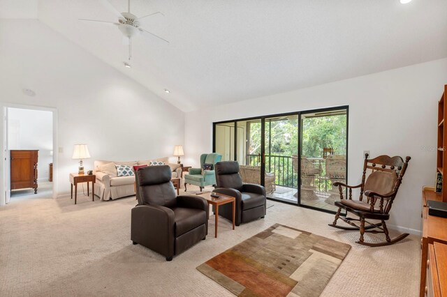 carpeted living room with high vaulted ceiling and ceiling fan