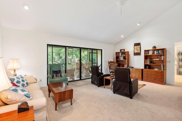 living room with ceiling fan, light colored carpet, and high vaulted ceiling