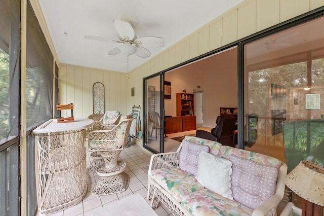 sunroom / solarium featuring ceiling fan and plenty of natural light