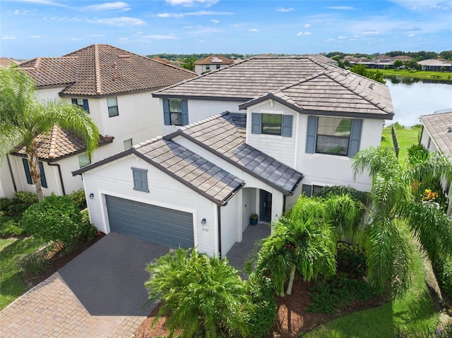 view of front of property with a water view and a garage