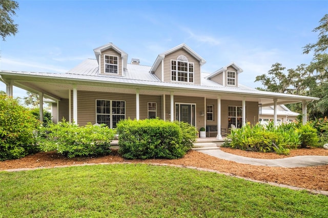 farmhouse inspired home with a porch and a front lawn