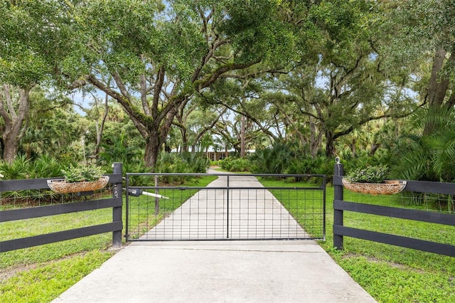 view of gate with a lawn