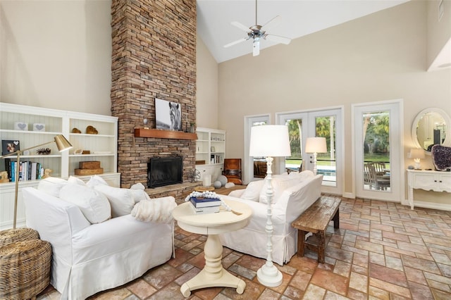 living room with high vaulted ceiling, a fireplace, and ceiling fan