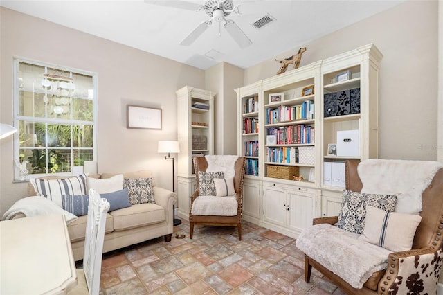 living area with ceiling fan