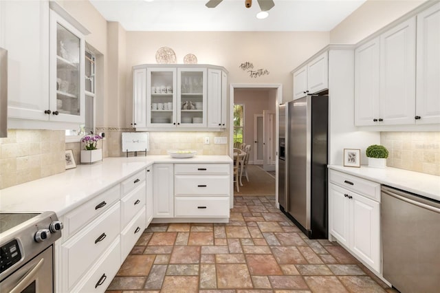 kitchen with white cabinets, stainless steel appliances, and tasteful backsplash