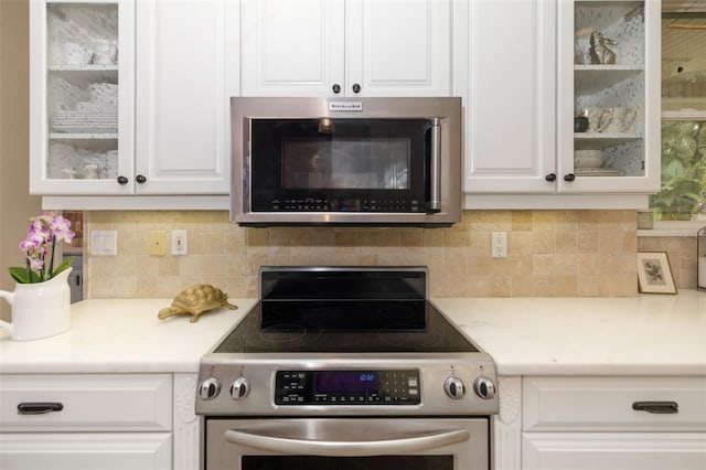 kitchen featuring white cabinetry, stainless steel appliances, and tasteful backsplash