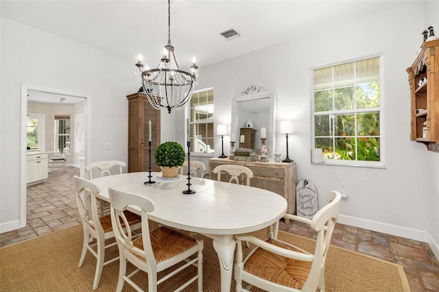 dining area featuring a wealth of natural light and a chandelier