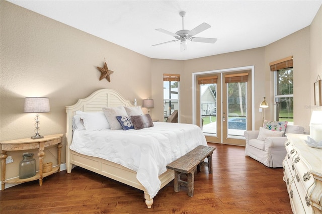 bedroom featuring dark hardwood / wood-style flooring, access to outside, and ceiling fan