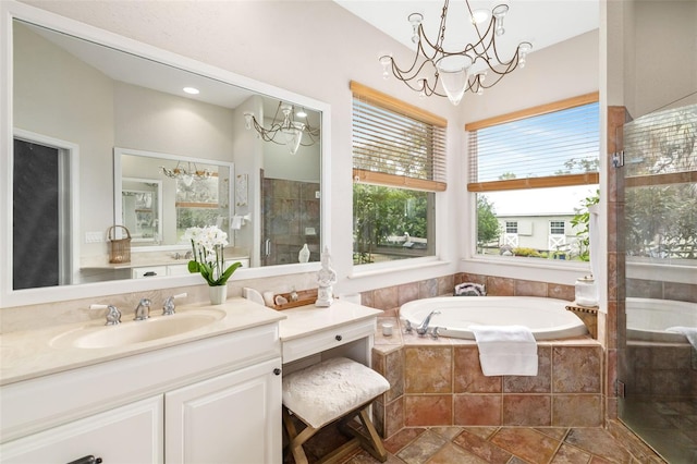 bathroom featuring vanity, shower with separate bathtub, and a notable chandelier