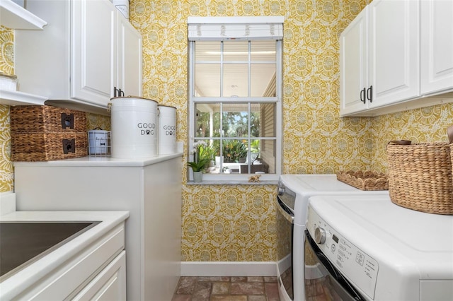 laundry room featuring cabinets and washing machine and clothes dryer