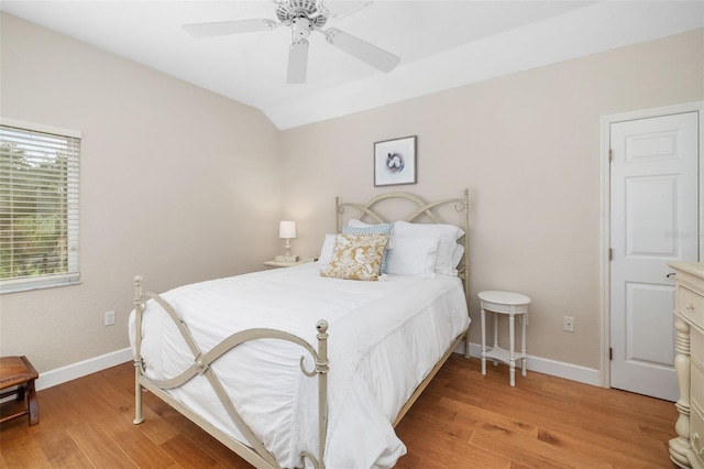 bedroom with lofted ceiling, light hardwood / wood-style floors, and ceiling fan