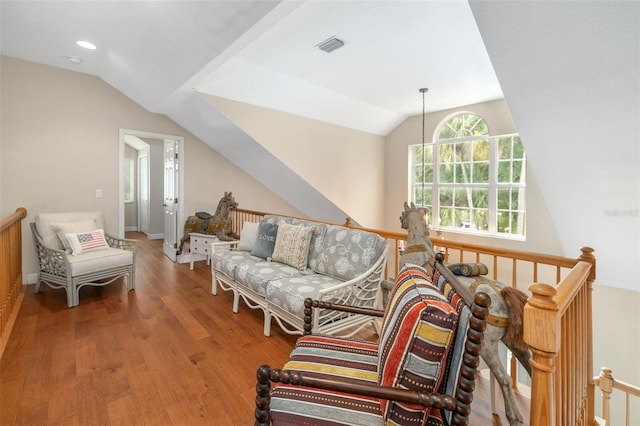 living room with a notable chandelier, wood-type flooring, and vaulted ceiling