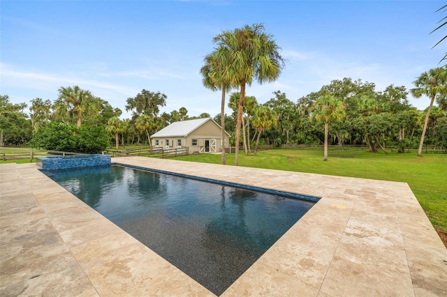 view of pool featuring a patio, an outbuilding, and a yard