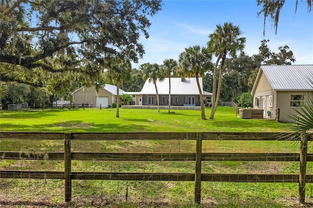 view of gate with a yard and a rural view