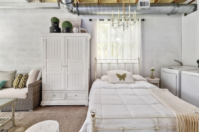 bedroom featuring washer and dryer and concrete flooring