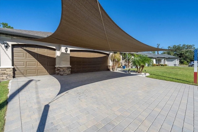 exterior space featuring a lawn and a garage