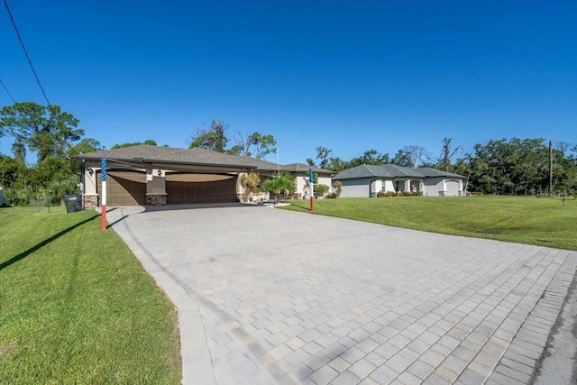 single story home featuring a garage, a carport, and a front lawn